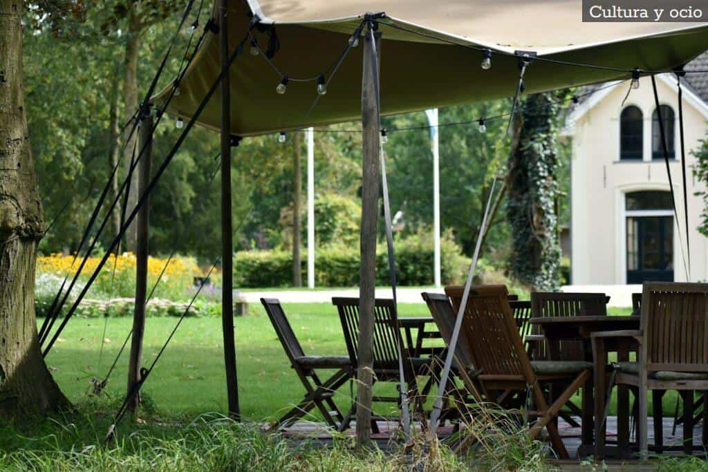 A table and chairs under a tent in the grass