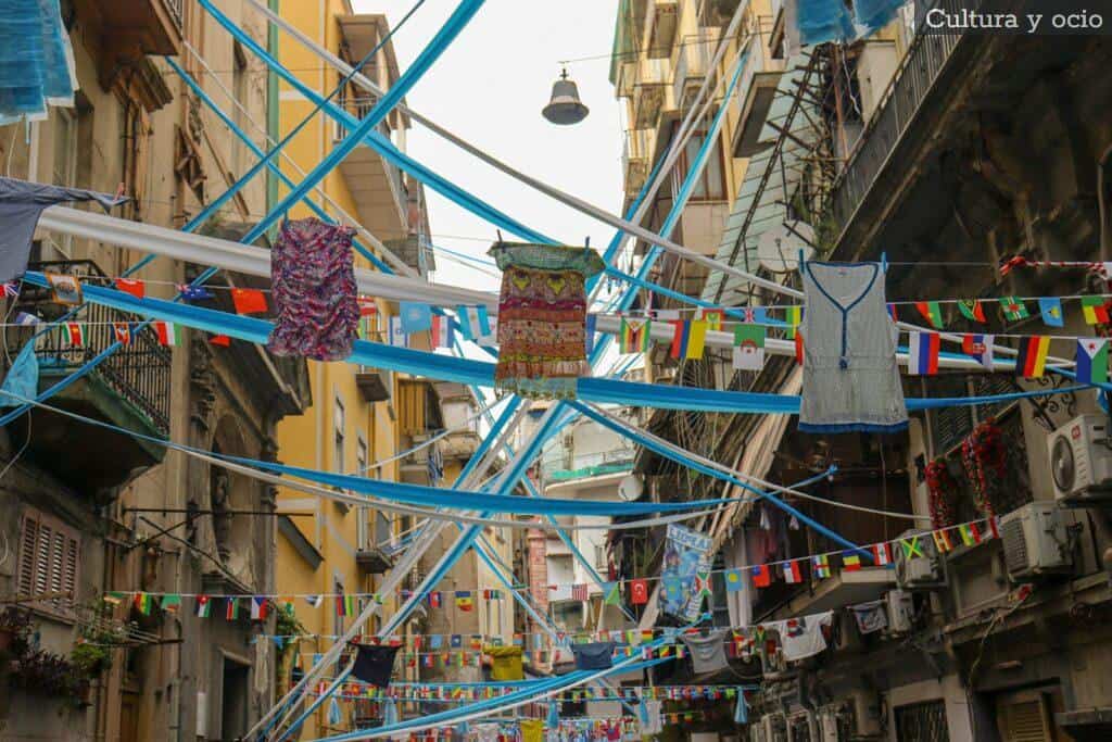 a city street filled with lots of laundry hanging from a line